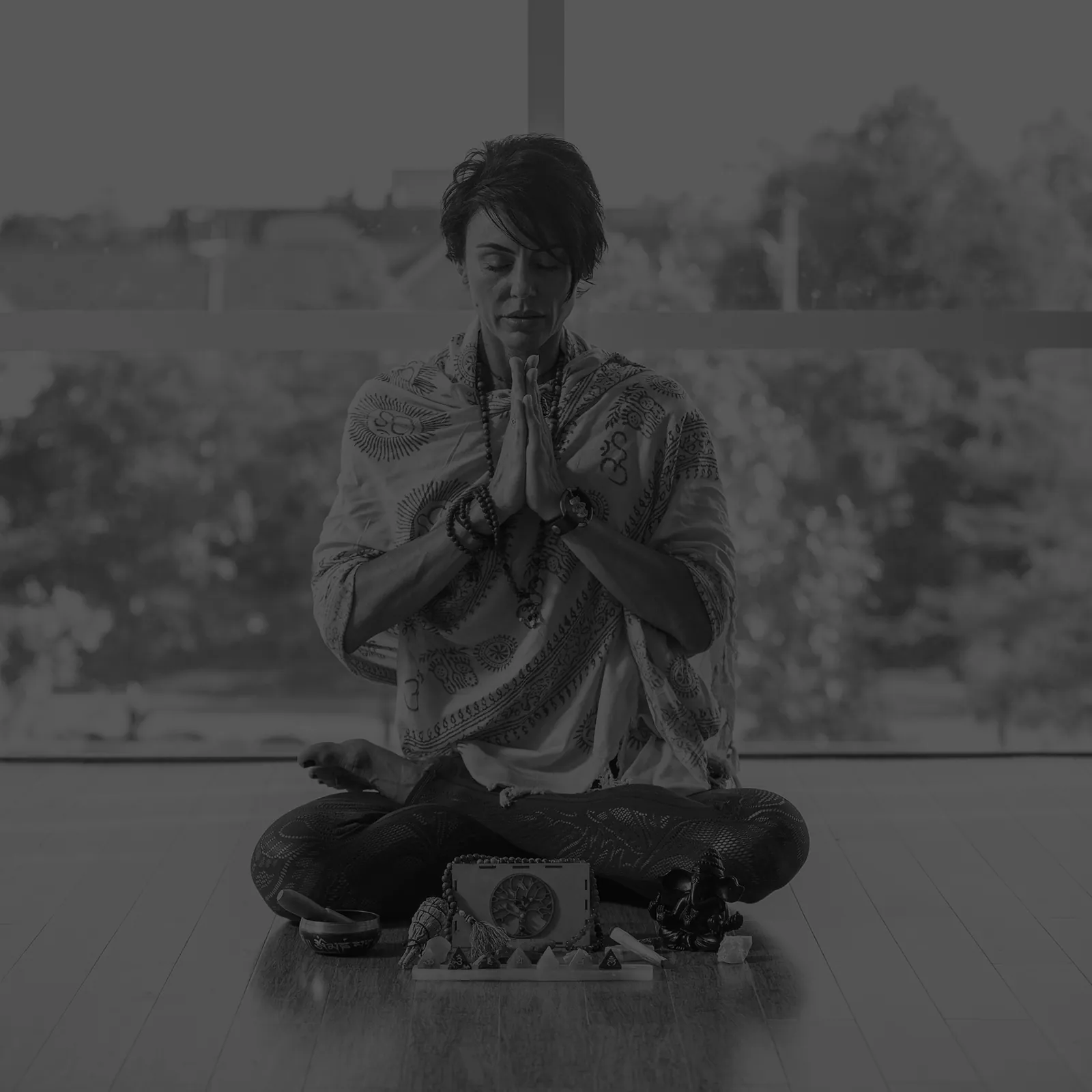 Melanie seated in stillness, hands at heart